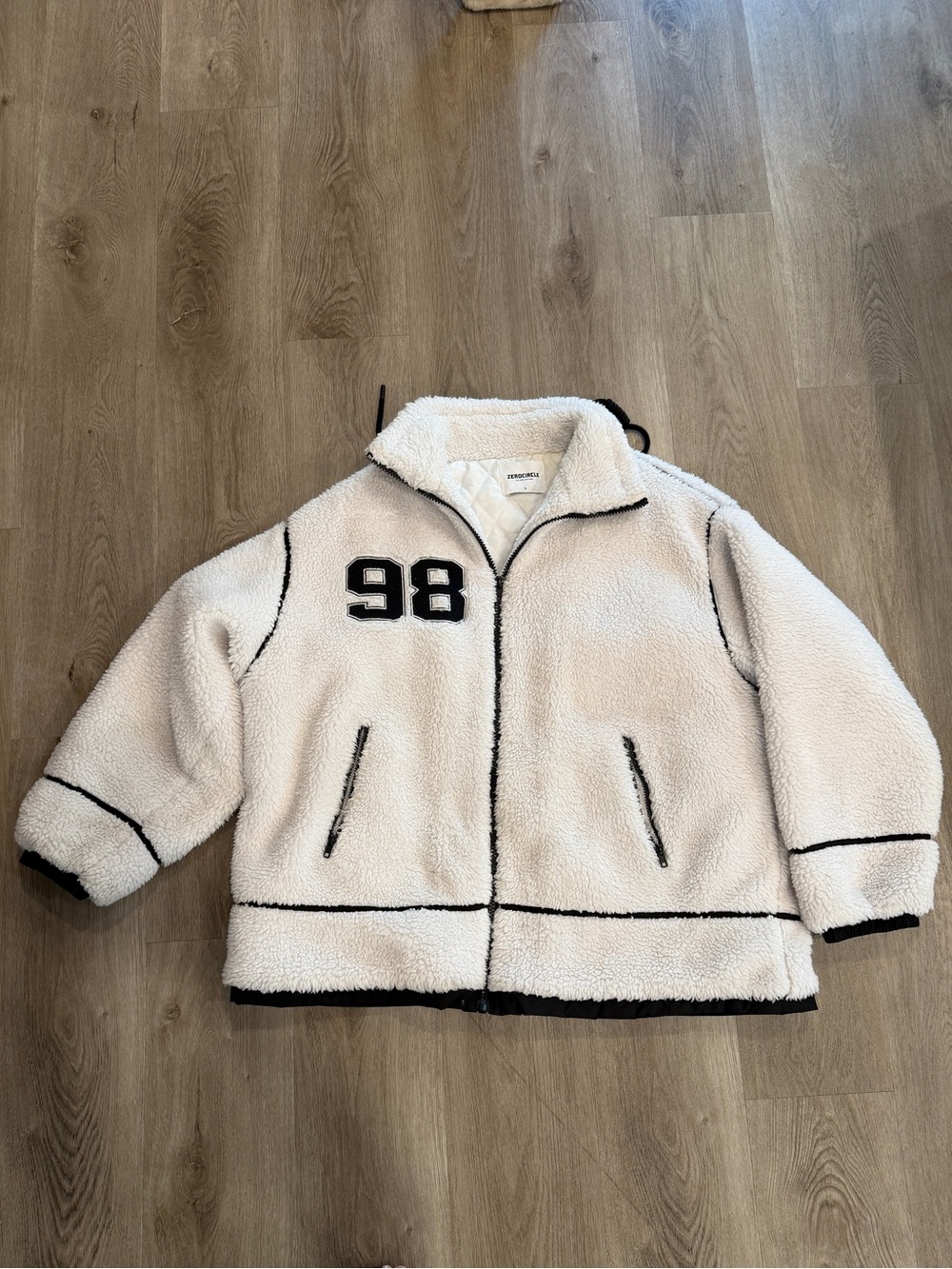 Oversized white sherpa jacket with black piping